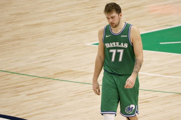 Dallas Mavericks guard Luka Doncic walks to the bench during a timeout in the second half of the team's NBA basketball game against the New York Knicks, Friday, April 16, 2021, in Dallas. (AP Photo/Ron Jenkins)