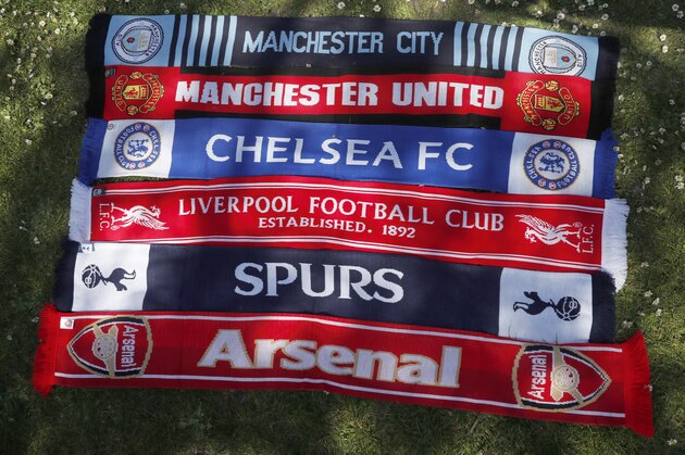 A selection of scarves of the English soccer Premier League teams who are reported to be part of a proposed European Super League, laid out and photographed, in London, Monday, April 19, 2021.  The 12 European clubs planning to start a breakaway Super League have told the leaders of FIFA and UEFA that they have begun legal action aimed at fending off threats to block the competition. (AP Photo/Alastair Grant)