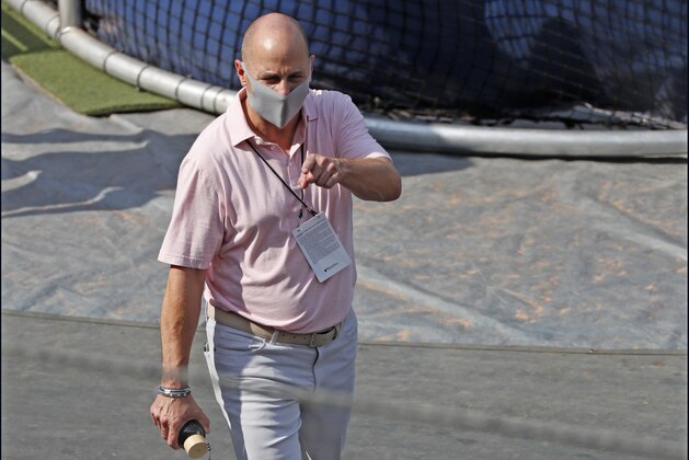 New York Yankees general manager Brain Cashman points to the dugout during batting practice before an exhibition baseball game against the New York Mets, Sunday, July 19, 2020, at Yankee Stadium in New York. (AP Photo/Kathy Willens)