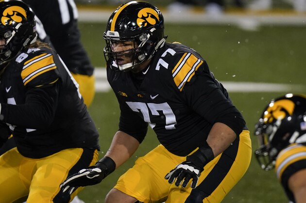 Iowa offensive lineman Alaric Jackson (77) looks to make a block during the second half of an NCAA college football game against Wisconsin, Saturday, Dec. 12, 2020, in Iowa City, Iowa. Iowa won 28-7. (AP Photo/Charlie Neibergall)