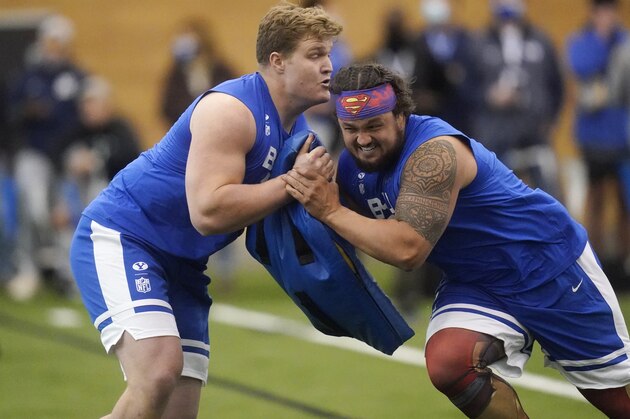 BYU offensive linemen Chandon Herring, left, and Tristen Hoge participate in the school's Pro Day football workout for NFL scouts Friday, March 26, 2021, in Provo, Utah. (AP Photo/Rick Bowmer)