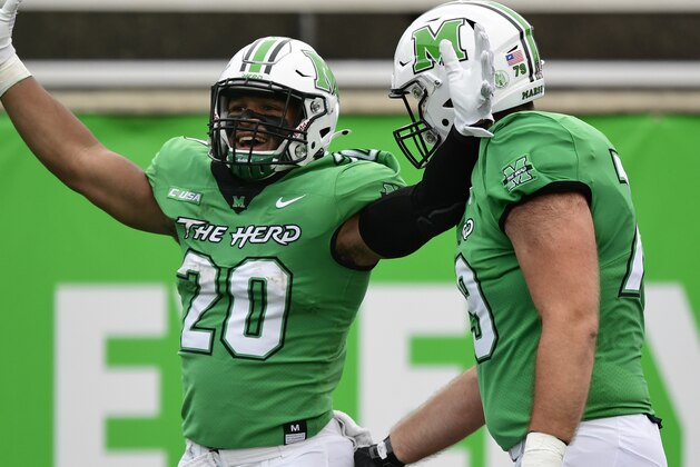 Marshall running back Brenden Knox (20) celebrates his touchdown with offensive lineman Josh Ball (79) in the first half during an NCAA football game against Florida Atlantic on Saturday, Oct. 24, 2020 in Huntington, W.VA. (AP Photo/Emilee Chinn)