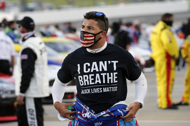 FILE - Driver Bubba Wallace wears a Black Lives Matter shirt as he prepares for a NASCAR Cup Series auto race Wednesday, June 10, 2020, in Martinsville, Va. NASCAR drivers don't plan to boycott Saturday night's, Aug. 29 race at Daytona International Speedway to raise awareness of social and racial injustices. Bubba Wallace, the only fulltime Black driver in the elite Cup Series, said that decision should not be interpreted as