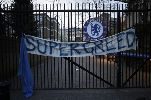 A banner hangs from one of the gates of Stamford Bridge stadium in London where Chelsea fans were protesting against Chelsea's decision to be included amongst the clubs attempting to form a new European Super League, Tuesday, April 20, 2021. Reaction to the proposals from 12 clubs to rip up European soccer by forming a breakaway Super League has ranged from anger and condemnation to humor and sarcasm. (AP Photo/Matt Dunham)