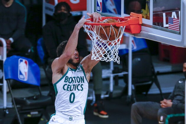 Boston Celtics' Jayson Tatum (0) dunks against the Los Angeles Lakers during the second half of an NBA basketball game, Thursday, April 15, 2021, in Los Angeles. (AP Photo/Ringo H.W. Chiu)