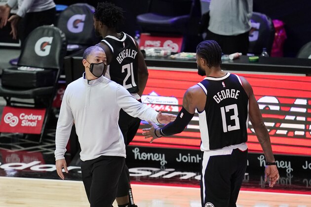 Los Angeles Clippers head coach Tyronn Lue, left, shakes hands with guard Paul George (13) during the second half of an NBA basketball game against the Chicago Bulls Sunday, Jan. 10, 2021, in Los Angeles. (AP Photo/Marcio Jose Sanchez)