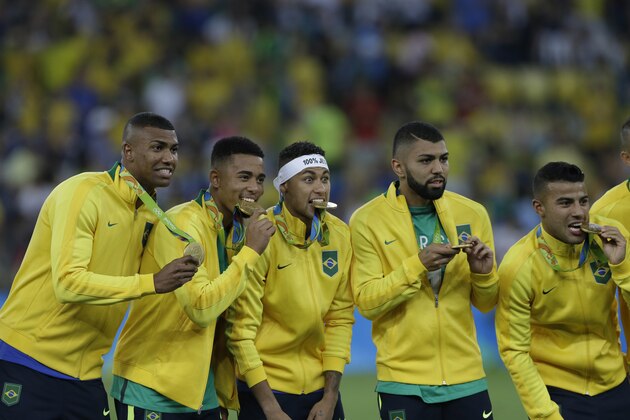 Brazil's players pose with their gold medals after the final match of the men's Olympic football tournament at Maracana stadium in Rio de Janeiro, Brazil, Saturday, Aug. 20, 2016. Brazil won the gold medal on penalty shoot-out. (AP Photo/Leo Correa)