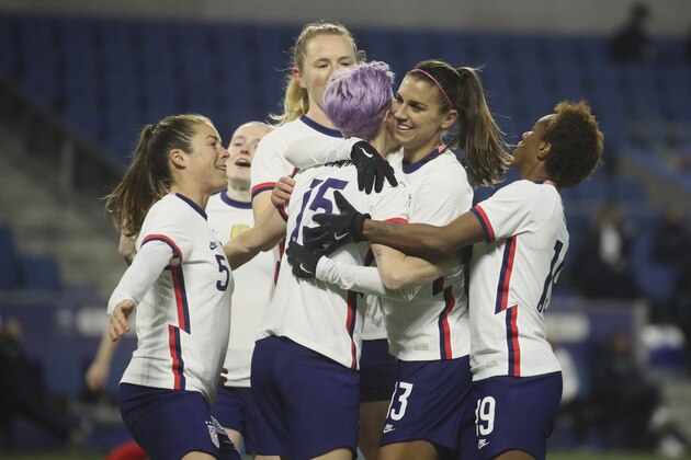 United States' Megan Rapinoe (15) is congratulated by teammates after scoring on a penalty kick during the first half of an international friendly women's soccer match between the United States and France in Le Havre, France, Tuesday, April 13, 2021. (AP Photo/David Vincent)