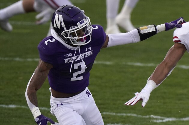 Wisconsin running back Jalen Berger, right, runs with the ball against Northwestern defensive back Greg Newsome II, during the first half of an NCAA college football game in Evanston, Ill., Saturday, Nov. 21, 2020. (AP Photo/Nam Y. Huh)