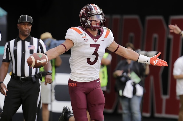 Virginia Tech defensive back Caleb Farley, left, reacts after intercepting a pass intended for Miami wide receiver Dee Wiggins, right, during the first half of an NCAA college football game, Saturday, Oct. 5, 2019, in Miami Gardens, Fla. (AP Photo/Lynne Sladky)