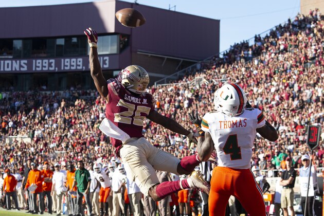 Florida State defensive back Asante Samuel Jr. (26) attempts an interception against Miami wide receiver Jeff Thomas (4) in the first half of an NCAA college football game in Tallahassee, Fla., Saturday, Nov. 2, 2019. (AP Photo/Mark Wallheiser)
