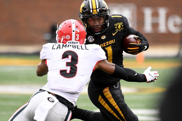 Missouri running back Tyler Badie, right, runs with the ball as Georgia defensive back Tyson Campbell (3) defends during the second half of an NCAA college football game Saturday, Dec. 12, 2020, in Columbia, Mo. (AP Photo/L.G. Patterson)