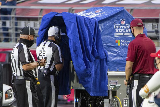 Referee Jerome Boger (23) reviews a play during an NFL football game between the Los Angeles Rams and Arizona Cardinals, Sunday, Dec. 6, 2020, in Glendale, Ariz. (AP Photo/Jennifer Stewart)