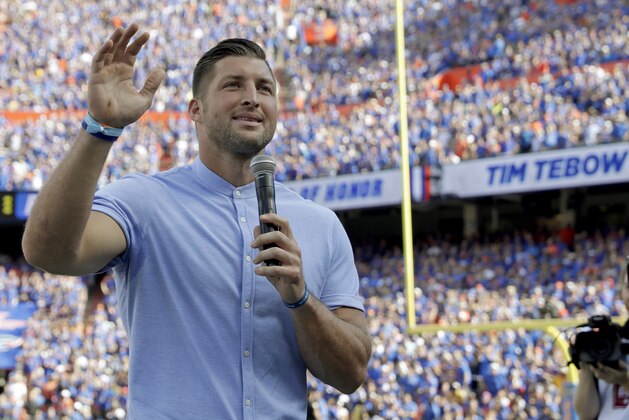 Former Florida football player Tim Tebow speaks to fans after he was inducted in the Ring of Honor at Florida Field during the first half of an NCAA college football game against LSU, Saturday, Oct. 6, 2018, in Gainesville, Fla. (AP Photo/John Raoux)