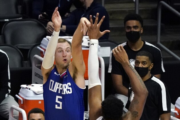 Los Angeles Clippers guard Luke Kennard (5) shoots over Memphis Grizzlies center Xavier Tillman (2) during the first half of an NBA basketball game Wednesday, April 21, 2021, in Los Angeles. (AP Photo/Marcio Jose Sanchez)