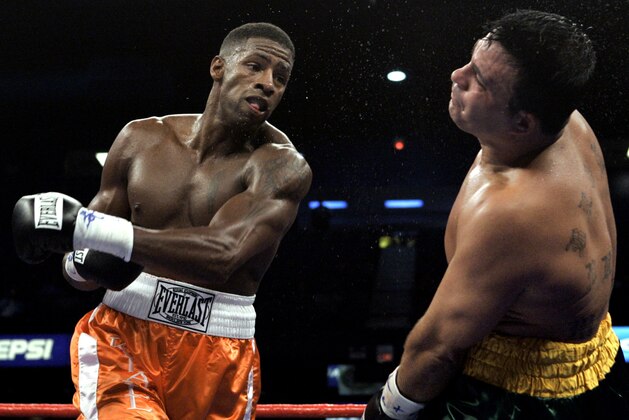 Jason Medina, right, stumbles after taking a punch to the head from Kendall Gill during the third round of cruiserweight action Saturday, Aug. 20, 2005 in Rosemont, Ill.. Gill defeated Medina in a unanimous decision. (AP Photo/Charles Rex Arbogast)