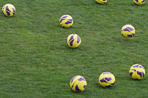 Jill Loyden, goalkeeper of the US women's soccer team, helps gather the balls at the end of a training session Thursday, March 7 2013, in Ferreiras, southern Portugal. Loyden had her hand in a bag of ice after getting injured during the training. On Friday the US will play China in their Algarve Cup second match. (AP Photo/Armando Franca)