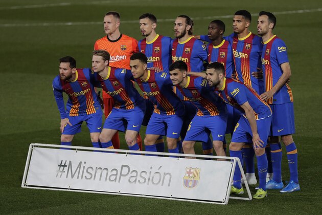 FC Barcelona players pose for photographers prior the Spanish La Liga soccer match between Real Madrid and FC Barcelona at the Alfredo di Stefano stadium in Madrid, Spain, Saturday, April 10, 2021. Board reads in Spanish: