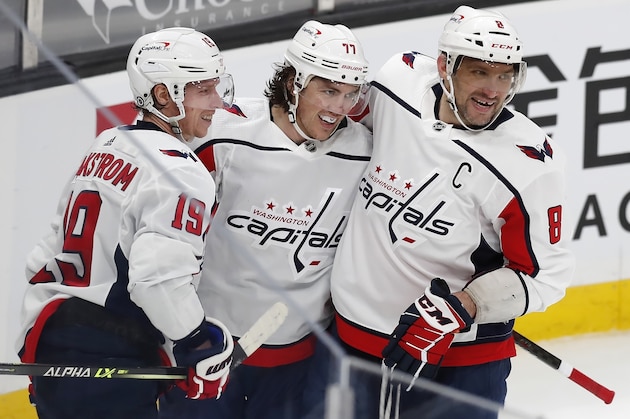 Washington Capitals' T.J. Oshie (77) celebrates his goal with teammates Nicklas Backstrom (19) and Alex Ovechkin (8) during the third period of an NHL hockey game against the Boston Bruins, Sunday, April 11, 2021, in Boston. (AP Photo/Michael Dwyer)