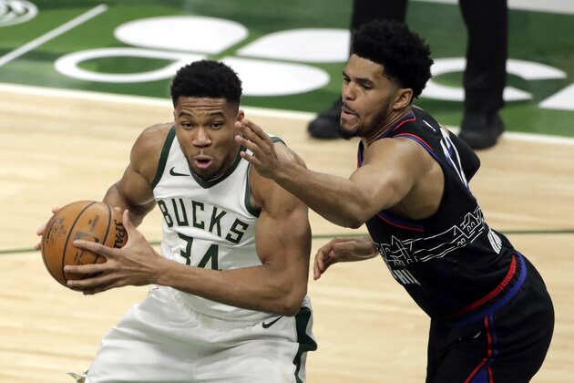 Milwaukee Bucks' Giannis Antetokounmpo drives to the basket against Philadelphia 76ers' Tobias Harris during the first half of an NBA basketball game Thursday, April 22, 2021, in Milwaukee. (AP Photo/Aaron Gash)