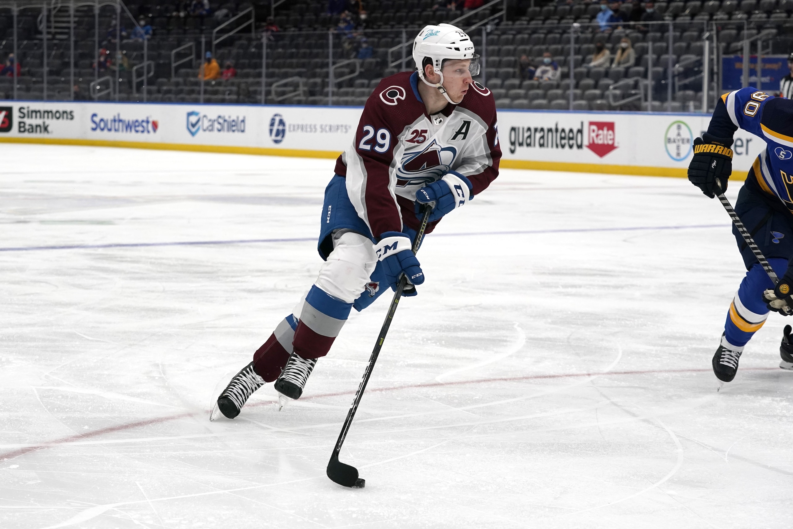 Colorado Avalanche's Nathan MacKinnon handles the puck during the first period of an NHL hockey game against the St. Louis Blues Thursday, April 22, 2021, in St. Louis. (AP Photo/Jeff Roberson)