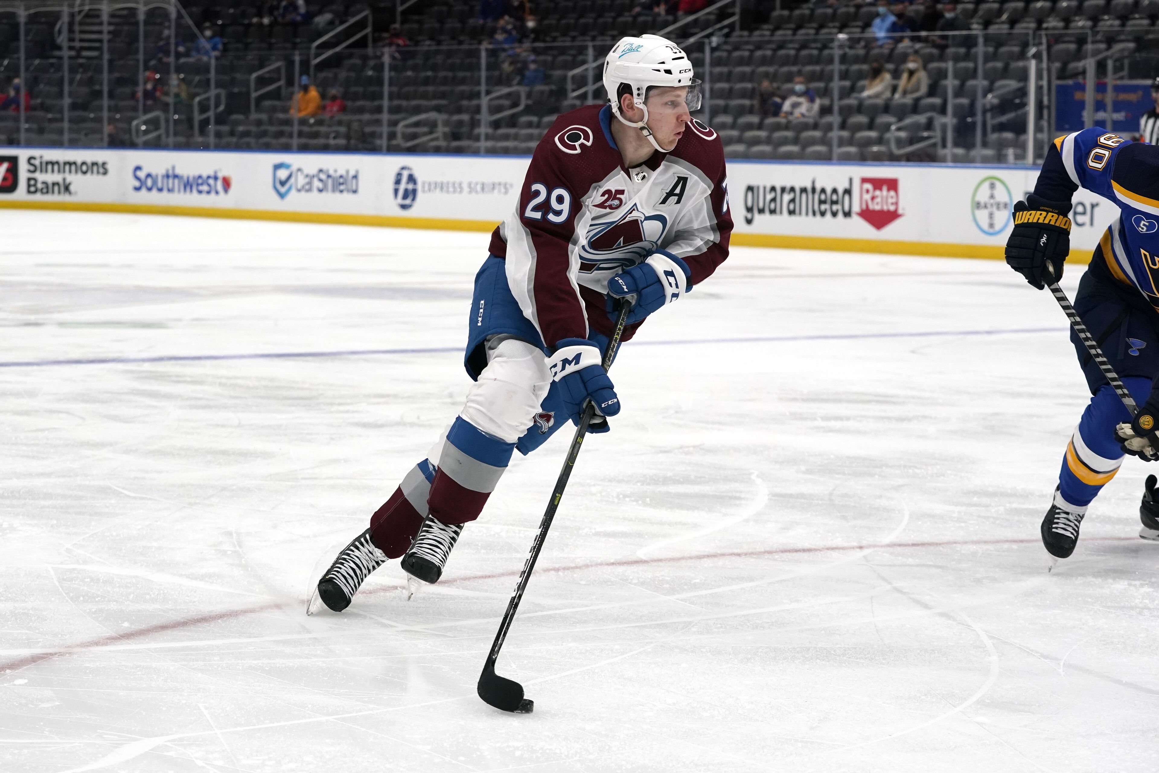 Colorado Avalanche's Nathan MacKinnon handles the puck during the first period of an NHL hockey game against the St. Louis Blues Thursday, April 22, 2021, in St. Louis. (AP Photo/Jeff Roberson)