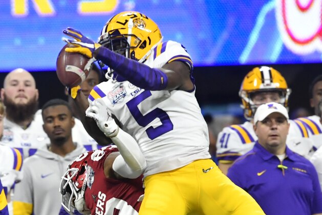 LSU cornerback Kary Vincent Jr. (5) picks off a ball intended for Oklahoma wide receiver Nick Basquine (83) during the first half of the Peach Bowl NCAA semifinal college football playoff game, Saturday, Dec. 28, 2019, in Atlanta. (AP Photo/John Amis)