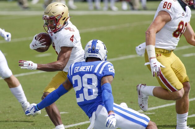 Boston College wide receiver Zay Flowers (4) runs after a catch as Duke Blue cornerback Mark Gilbert (28) tries to make the tackle during the first half of an NCAA college football game, Saturday, Sept. 19, 2020, in Durham, N.C. (Nell Redmond/Pool Photo via AP)