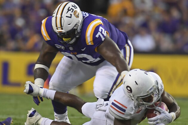 Northwestern State wide receiver Akile Davis (9) catches a pass as LSU nose tackle Tyler Shelvin (72) defends in the first half of an NCAA college football game, Saturday, Sept. 14, 2019, in Baton Rouge, La. (AP Photo/Patrick Dennis)