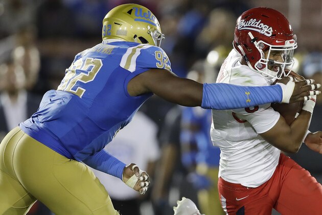 Fresno State quarterback Marcus McMaryion, right, is tackled by UCLA defensive lineman Osa Odighizuwa during the second half of an NCAA college football game, Saturday, Sept. 15, 2018, in Pasadena, Calif. (AP Photo/Marcio Jose Sanchez)