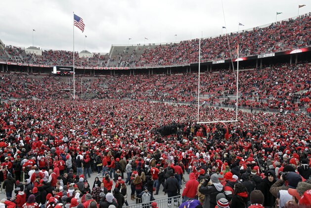 In this Nov. 24, 2012 photo, Ohio State fans celebrate on the field after a win over Michigan in an NCAA college football game in Columbus, Ohio. Ahead of the 2014 college football season, the AP asked its panel of Top 25 voters, who are known for ranking the nation's top teams each week, to weigh in on which stadium had the best game day atmosphere. Ohio State’s Horseshoe received recognition from the panel. (AP Photo/Mark Duncan, File)