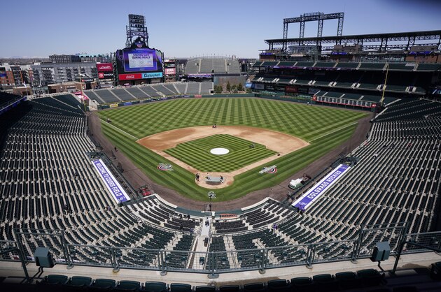 Workers prepare Coors Field on Wednesday, March 31, 2021, in Denver, the day before the Colorado Rockies' season-opener against the Los Angeles Dodgers. (AP Photo/David Zalubowski)
