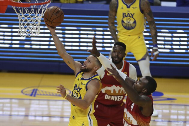Golden State Warriors' Stephen Curry, left, shoots against Denver Nuggets' Paul Millsap at an NBA basketball game in San Francisco, Friday, April 23, 2021. (AP Photo/Jed Jacobsohn)