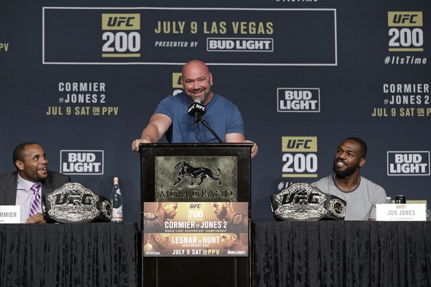 Dana White, center, stands between Daniel Cormier, left, and Jon Jones during a UFC 200 mixed martial arts news conference, Wednesday, July 6, 2016, in Las Vegas. Cormier and Jones are scheduled to fight in a light heavyweight championship fight at UFC 200 on Saturday. (AP Photo/John Locher)