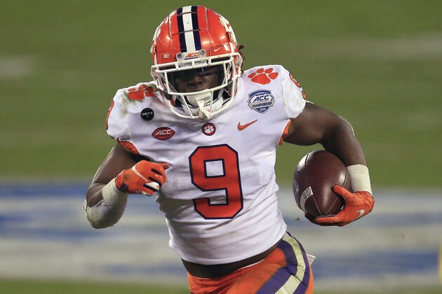 FILE - In this Saturday, Dec. 19, 2020 file photo, Clemson running back Travis Etienne (9) runs for a touchdown during the first half of the Atlantic Coast Conference championship NCAA college football game against Notre Dame in Charlotte, N.C. Brandon Beane didn’t entirely rule out the possibility of adding a running back in the first two rounds, with Clemson’s Travis Etienne and Alabama’s Najee Harris rated as the top prospects.(AP Photo/Brian Blanco, File)