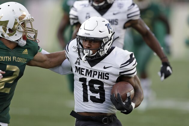 Memphis running back Kenneth Gainwell (19) pushes off South Florida defensive back Nick Roberts (2) during the first half of an NCAA college football game Saturday, Nov. 23, 2019, in Tampa, Fla. (AP Photo/Chris O'Meara)