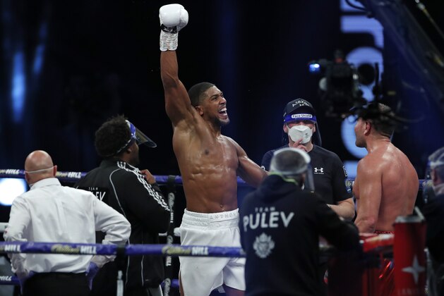 World Heavyweight boxing champion Britain's Anthony Joshua celebrates after beating challenger Bulgaria's Kubrat Pulev to win their Heavyweight title fight at Wembley Arena in London Saturday, Dec. 12, 2020. (Andrew Couldridge/Pool via AP)