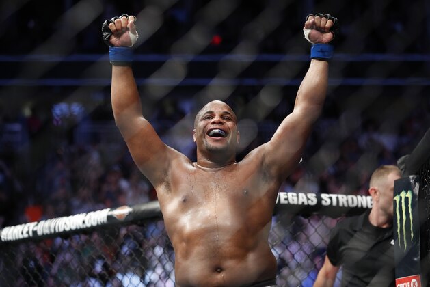 FILE - In this July 7, 2018, file photo, Daniel Cormier celebrates after defeating Stipe Miocic in a heavyweight title mixed martial arts bout at UFC 226 in Las Vegas. Cormier will defend the title against Derrick Lewis in the main event of UFC 230 on Nov. 3 against Madison Square Garden in New York. (AP Photo/John Locher, File)