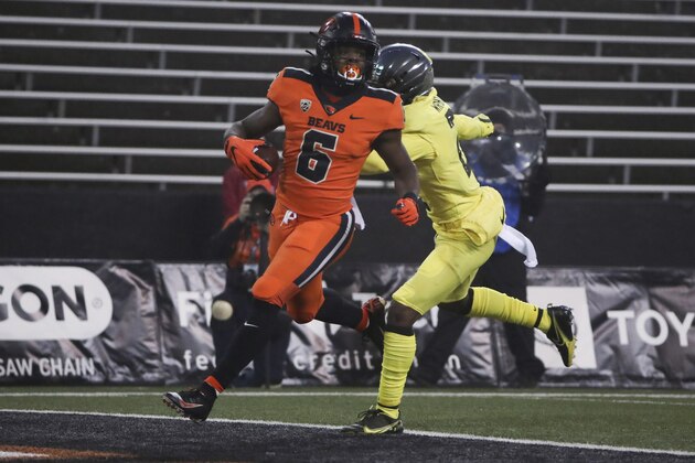 Oregon State running back Jermar Jefferson (6) runs past Oregon cornerback Mykael Wright (2) and into the end zone for a touchdown during the first half of an NCAA college football game in Corvallis, Ore., Friday, Nov. 27, 2020. (AP Photo/Amanda Loman)