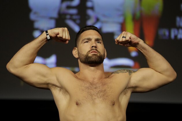 Chris Weidman stands atop a scale during the weigh-ins ahead his mixed martial arts middleweight bout against Ronaldo Souza at UFC 230, Friday, Nov. 2, 2018, at Madison Square Garden in New York. (AP Photo/Julio Cortez)