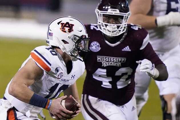Auburn quarterback Bo Nix (10) is pursued by Mississippi State defensive end Marquiss Spencer (42) during the second half of an NCAA college football game, Saturday, Dec. 12, 2020, in Starkville, Miss. (AP Photo/Rogelio V. Solis)