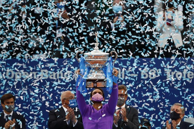 Rafael Nadal of Spain lifts the trophy after winning the final Godo tennis tournament against Stefanos Tsitsipas of Greece in Barcelona, Spain, Sunday, April 25, 2021. Nadal won by 6-4, 6-7, 7-5 (AP Photo/Joan Monfort)