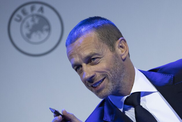 FILE - In this March 3, 2020 file photo UEFA President Aleksander Ceferin looks up during a meeting of European soccer leaders at the congress of the UEFA governing body in Amsterdam's Beurs van Berlage, Netherlands. The 12 European clubs pursuing a Super League have told the leaders of FIFA and UEFA that legal action is already being pursued to stop them from action intended to thwart the launch of the breakaway competition, according to a letter obtained Monday by The Associated Press. The letter was sent by the group of English, Spanish and Italian clubs to FIFA President Gianni Infantino and UEFA counterpart Aleksander Ceferin saying the Super League has already been underwritten by funding of 4 billion euros ($5.5 billion) from a financial institution. (AP Photo/Peter Dejong, File)