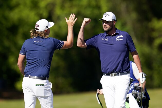 Marc Leishman, of Australia, celebrates with teammate Cameron Smith, of Australia, left, after making a putt on the 16th green during the final round of the PGA Zurich Classic golf tournament at TPC Louisiana in Avondale, La., Sunday, April 25, 2021. (AP Photo/Gerald Herbert)