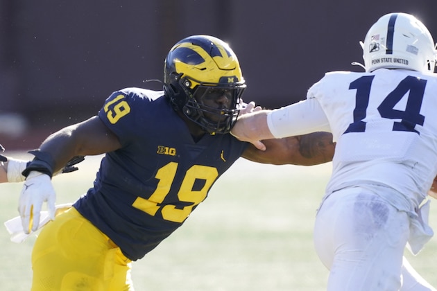 FILE - In this  Saturday, Nov. 28, 2020 file photo, Michigan defensive lineman Kwity Paye (19) reaches in on Penn State quarterback Sean Clifford (14) during the second half of an NCAA college football game in Ann Arbor, Mich. With Oregon's Penei Sewell likely to be long gone, two other heralded tackles could be available to the Vikings at No. 14: Northwestern's Rashawn Slater and Virginia Tech's Christian Darrisaw. Slater has a random connection to Minnesota: His father, Reggie Slater, played in the NBA for the Timberwolves in parts of two seasons.(AP Photo/Carlos Osorio, File)