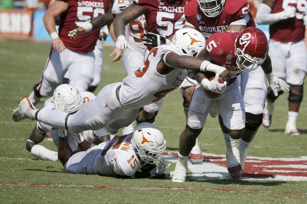 Texas linebacker Joseph Ossai (46) forces a fumble by Oklahoma running back T.J. Pledger (5) during an NCAA college football game in Dallas, Saturday, Oct. 10, 2020. (AP Photo/Michael Ainsworth)