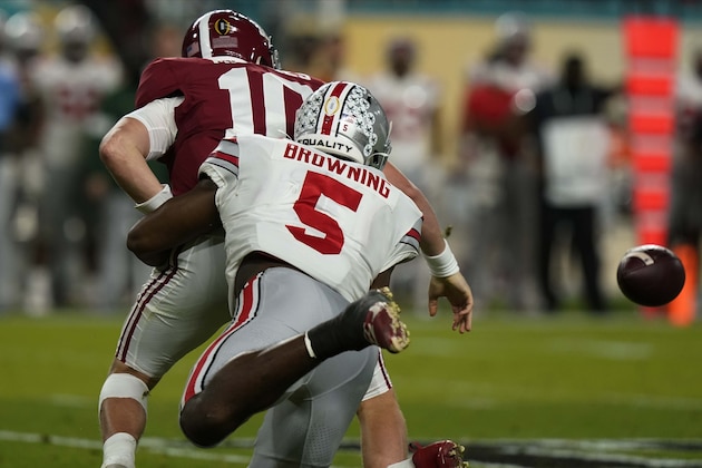 Ohio State linebacker Baron Browning forces a fumble by Alabama quarterback Mac Jones during the first half of an NCAA College Football Playoff national championship game, Monday, Jan. 11, 2021, in Miami Gardens, Fla. (AP Photo/Lynne Sladky)