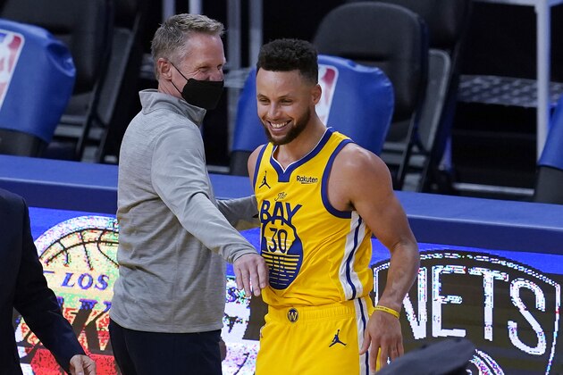 Golden State Warriors coach Steve Kerr, left, celebrates with guard Stephen Curry after the Warriors defeated the Milwaukee Bucks in an NBA basketball game in San Francisco, Tuesday, April 6, 2021. (AP Photo/Jeff Chiu)