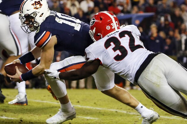 Auburn quarterback Bo Nix (10) carries the ball in for a touchdown as he gets past Georgia linebacker Monty Rice (32) during the second half of an NCAA college football game, Saturday, Nov. 16, 2019, in Auburn, Ala. (AP Photo/Butch Dill)