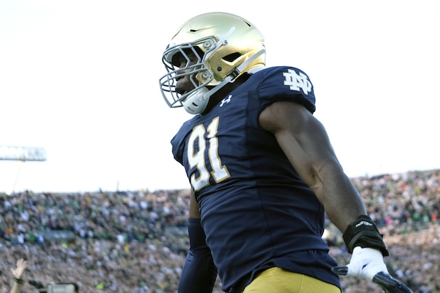 Notre Dame defensive lineman Adetokunbo Ogundeji (91) reacts after scoring a touch down on a fumble recovery while playing Virginia in the second half of an NCAA college football game in South Bend, Ind., Saturday, Sept. 28, 2019. Notre Dame won 35-20. (AP Photo/AJ Mast)